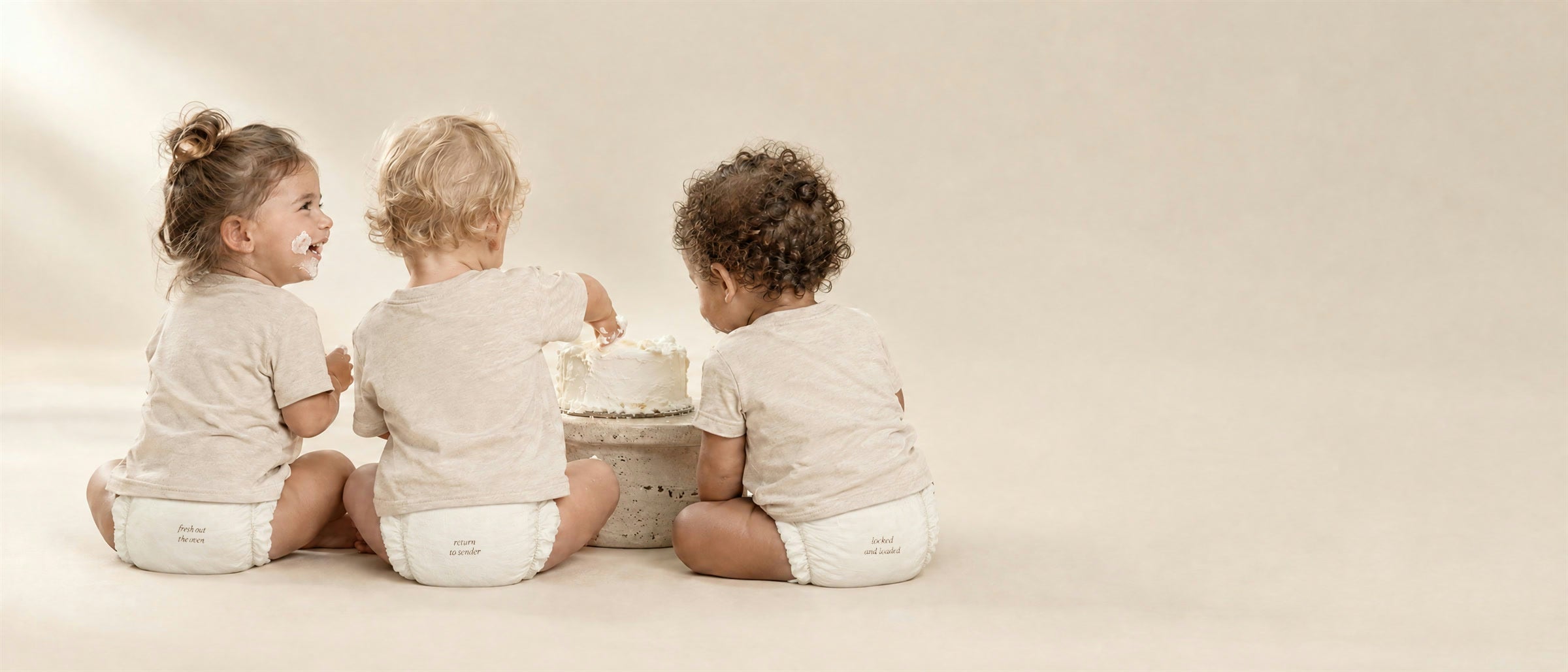 Three toddlers in Softy diapers sharing a birthday cake, diapers printed fresh out the oven, return to sender and locked and loaded